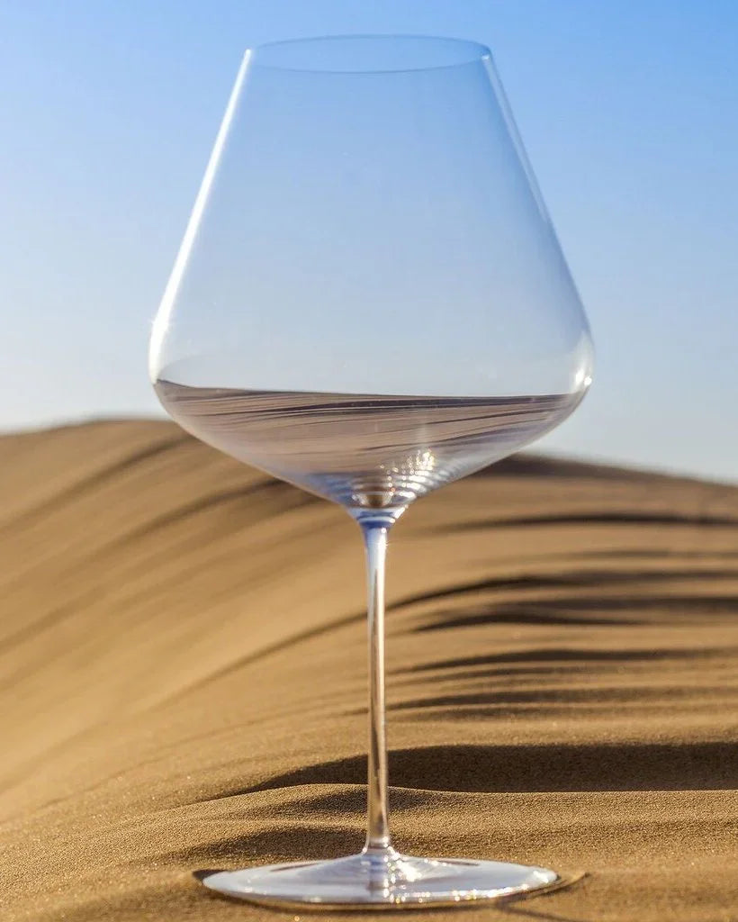 Zalto Burgundy glass standing on a sand dune