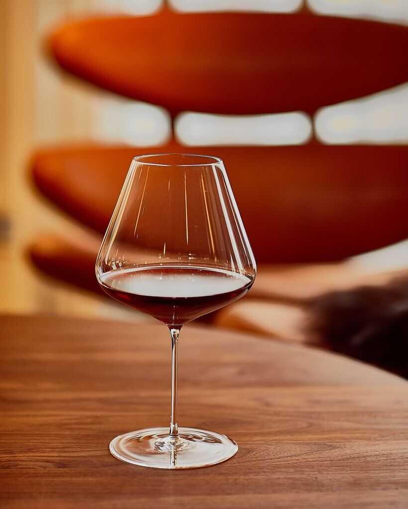 Zalto Burgundy glass of red wine on a wooden table